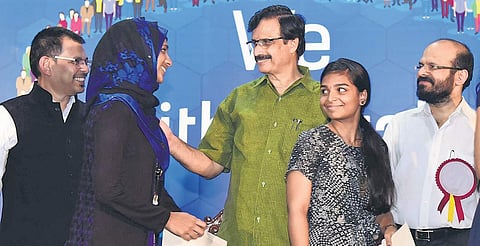 Education Minister C Raveendranath handing over the scholarships sponsored by Legrand to meritorious students from flood-affected areas | Albin Mathew