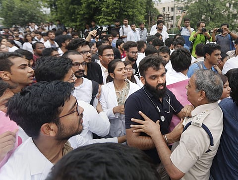 Police personnel scuffle with medical students as they protest against National Medical Commission NMC Bill outside Safdarjung Hospital in New Delhi Saturday August 3 2019. | PTI