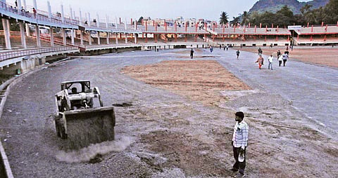 VMC workers take up restoration work at the athletic track at the IGMC Stadium in Vijayawada on Thursday I Prasant Madugula