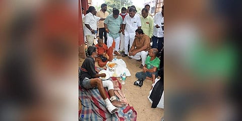 BJP MLA Raja Singh speaking to a labourer in OGH on Thursday. (Photo | RVK Rao, EPS)