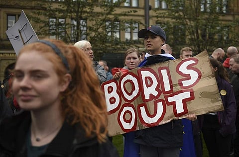Demonstrators hold up placards they gather to join a protest against the move to suspend parliament in the final weeks before Brexit in Manchester (Photo | AFP)