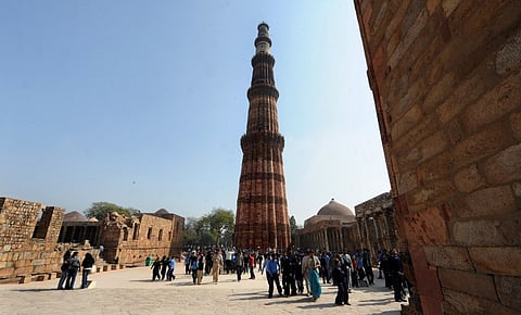 School children and tourists visit the historic landmark Qutub Minar in New Delhi. (Photo | AFP)