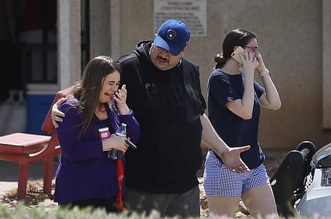 People arrive at MacArthur Elementary looking for family and friends as the school is being used a re-unification center during the aftermath of a shooting at the Walmart near the Cielo Vista Mall, Saturday, Aug. 3, in El Paso, Texas. (Photo | AP)