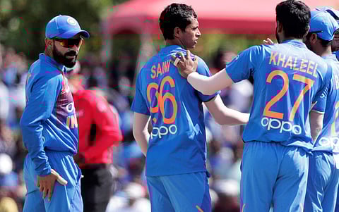 India's Navdeep Saini (96) is congratulated by Khaleel Ahmed (27) after taking the wicket of West Indies' Nicholas Pooran during the first T20I in Lauderhill, Fla. (Photo | AP)