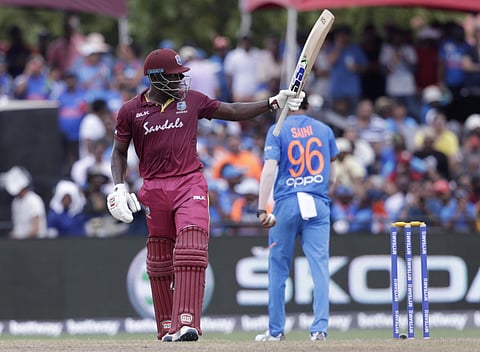 West Indies' Rovman Powell raises his bat after scoring fifty runs during the second Twenty20 international cricket match against India. (Photo | AP)