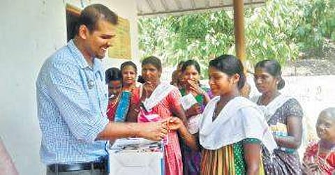 National Health Mission workers handing over medical equipment to volunteers