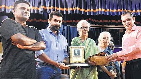 Actor Surya presents Maria Montessori Award to Uma Shankar, director,Indian Montessori Centre, on Sunday | D SAMPATHKUMAR
