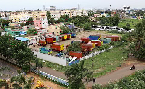 Buses and trucks stationed at the fenced parking lot which was once the Adayalapattu lake near Millennium Town Phase 1 Madurvoyal in the city. (Photo | Debadatta Mallick)