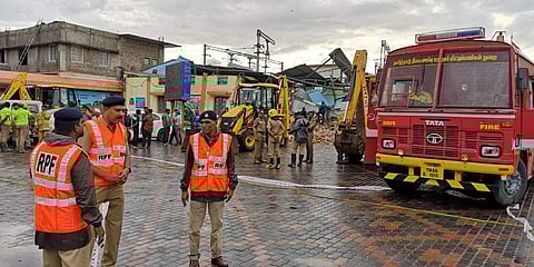 Rescue personnel at the Coimbatore railway station where the parcel booking office came crashing down due to heavy rain (Photo | EPS)