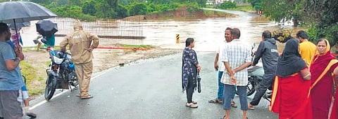 People stranded as water flows over low lying bridge near Korukonda (Photo |EPS)