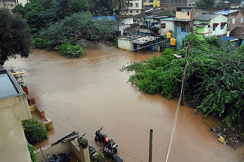 A view of a flood-affected area due to overflow of a water channel following heavy monsoon rain in Hubballi district of Karnataka (Photo | PTI)