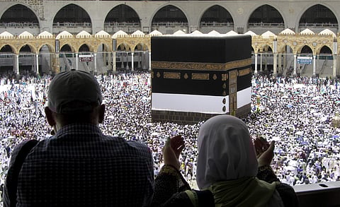 Muslim pilgrims pray as they watch thousands of pilgrims circumambulate around the Kaaba, the cubic building at the Grand Mosque, ahead of the Hajj pilgrimage in the Muslim holy city of Mecca, Saudi Arabia, Friday, Aug. 9, 2019. (Photo | AP)