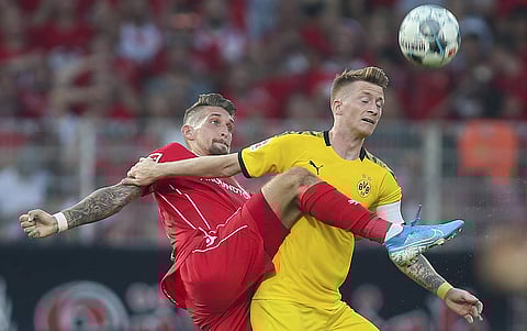 Berlin's Robert Andrich, left, and Marco Reus of Borussia Dortmund battle for the ball during a German Bundesliga soccer match between FC Union Berlin and Borussia Dortmund in Berlin, Germany. (Photo | AP)