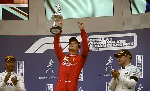 Ferrari driver Charles Leclerc of Monaco lifts the trophy after finishing first in the Belgian F1 Grand Prix in Spa-Francorchamps, Belgium. (Photo | AP)