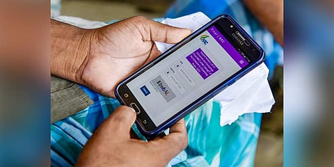 A person checks the final list of NRC that was released on a mobile phone, in Morigaon on 31st August, 2019. (Photo | PTI)