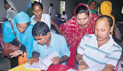 People check the final list for their names Saturday at an NRC centre in Morigaon, Assam. (Photo | PTI)