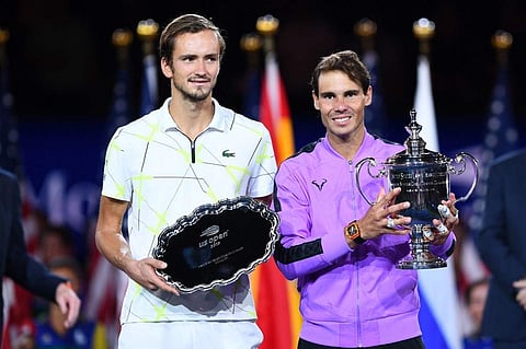 Rafael Nadal of Spain (R) holds the trophy after his win over Daniil Medvedev of Russia (L) during the men's Singles Finals match at the 2019 US Open. (Photo | AFP)