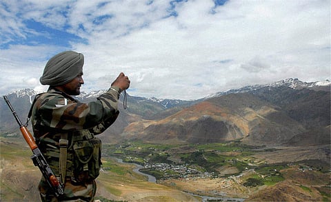 An army jawan takes pictures of Drass valley. (Photo| PTI)