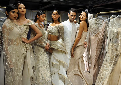 Models showcase the creations by fashion designer Gaurav Gupta. (Photo| PTI)