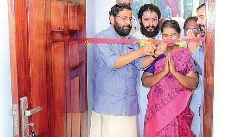 Devaswom Minister Kadakampally Surendran accompanies Ramani as she enters her new house built by the TDB at Vellarada on Tuesday | Express