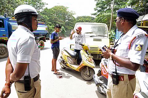 Traffic policemen check motorists on Wednesday. (Photo | Nagaraj Gadekal, EPS)