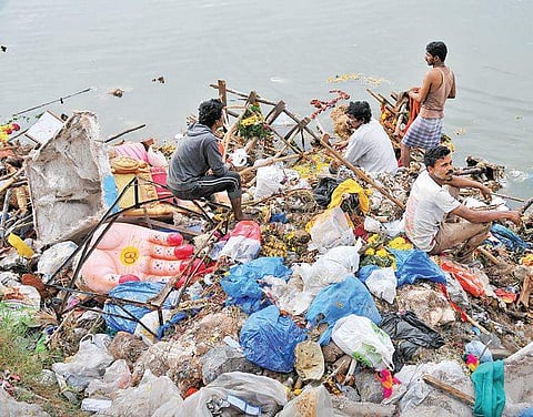Metal scrappers collect iron rods and other material from Ganesh idols at Hussainsagar | S Senbagapandiyan