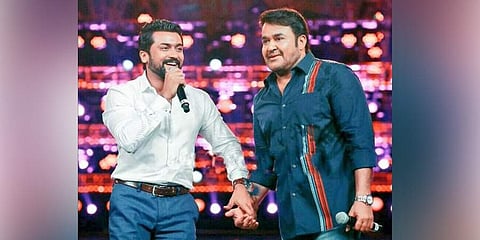 Actors Mohanlal and Suriya hold hands during the audio launch of 'Kaappaan'. (Photo | File, Twitter)
