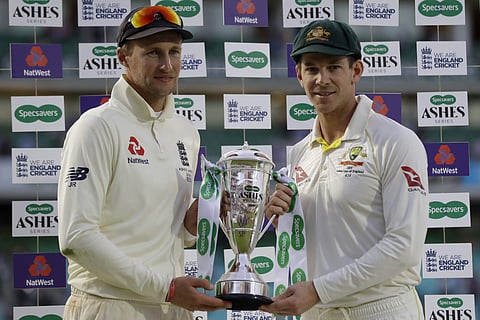 England's Joe Root, left, and Australia's Tim Paine hold the Ashes trophy during the presentation ceremony. (Photo | AP)