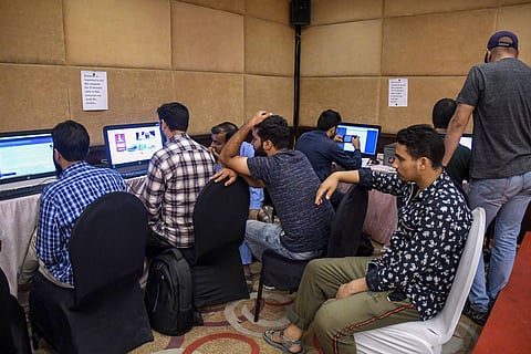 Journalists wait for their turn to access the internet at a temporary media centre set up by the government on the 42nd day following the abrogation of Article 370 in Srinagar Sunday September 15 2019. | PTI