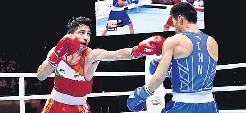 Kavinder Singh Bisht (left) won by a split verdict (3-2) against China’s Chen Zhihao