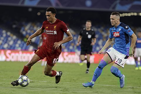 Liverpool's Trent Alexander-Arnold, left, controls the ball as Napoli's Piotr Zielinski looks on during the Champions League. (Photo | AP)