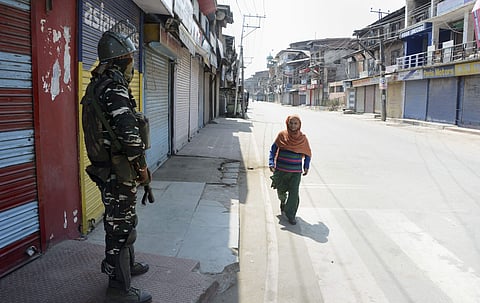 Security person stands guard at a closed market on the 44th day of strike after the abrogration of Article 370 and bifurcation of state in Srinagar Tuesday September 17 2019. | PTI