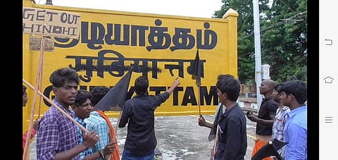 DMK cadre defacing the Hindi signage at Gudiyatham railway station. (Photo | EPS)