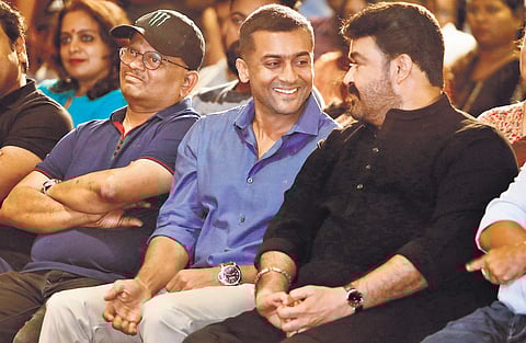 Mohanlal and Suriya sharing a light moment at the promotions of Kaappaan in Kochi on Tuesday. Director K V Anand is also seen. (Photo | ARUN ANGELA, EPS)