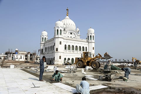 Workers give finishing touches to the shrine of Sikh spiritual leader Guru Nanak Dev, in Kartarpur. (Photo | AP)