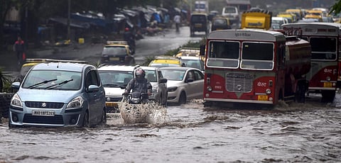 Vehicles wade through a waterlogged road af ter heavy downpour in Mumbai. (File Photo | PTI)
