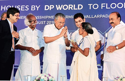 Chief Minister Pinarayi Vijayan greeting Ambujakshi, a beneficiary after handing over the keys of houses built under ‘Rebuild Kerala’ scheme. Ports Minister Ramachandran Kadannanppally and Hibi Eden MP are also seen (Photo| EPS, Arun Angela)
