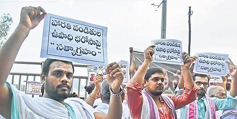 Harathi priests protest at Durga Ghat in the city on Thursday I Ravindra Babu