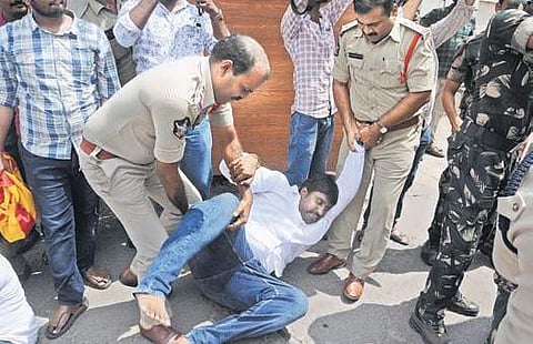 Police arrest TNSF activists while staging a protest against alleged village volunteer recruitment question paper leakage at the APPSC office in Vijayawada on Friday (Photo| EPS, Prasant Madugula)
