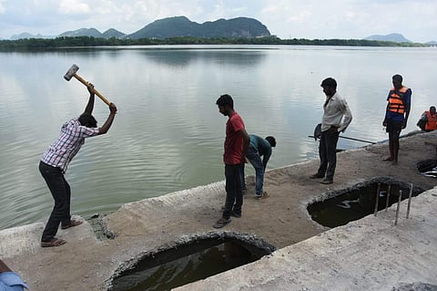 CRDA officials demolishing an illegal ramp that belongs to an Andhra farmer. The ramp was built eight metres into river Krishna in Vijayawada. (Photo | P Ravindra Babu, EPS)