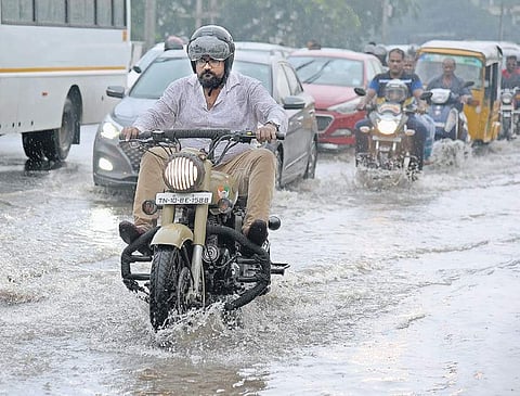 Vehicles wade through a water-logged road at Manapakkam. |( Photo | Martin Louis )