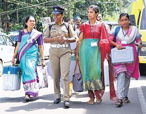 The polling officials assigned to the lone pink booth (all-woman polling booth) set up at St Vincent’s English Medium School, Kizhathadiyoor, heading to the booth after collecting polling materials from Carmel School, Pala, on Sunday