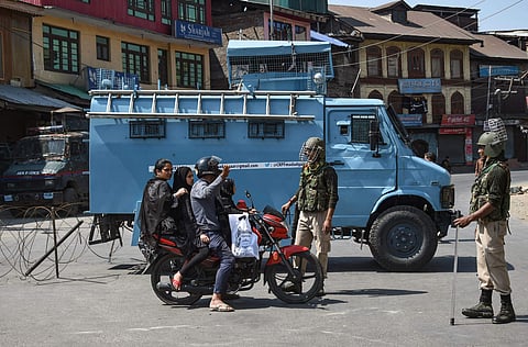 Security personnel divert traffic during restrictions in Srinagar. (File| PTI)