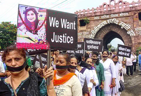Bhopal Activists of Sindhi and Sikh community cover their mouths as they display placards during a protest rally against the alleged discrimination on their communities in Pakistan in Bhopal Saturday Sept. 21 2019. (Photo | PTI)