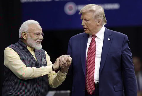 Prime Minister Narendra Modi and President Donald Trump shake hands after introductions during the 'Howdi Modi' event. (Photo | AP)