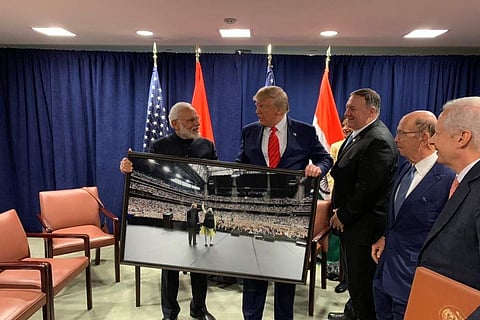 PM Narendra Modi presented a framed photograph from the #HowdyModi event to Donald Trump. (Photo | Twitter/@PMOIndia)