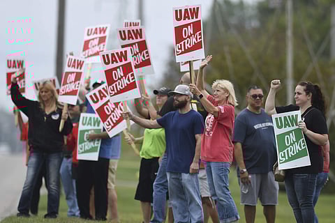 United Auto Workers members picket outside of the General Motors Lansing Delta Township plant. (Photo | AP)