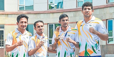 (From left) Kavinder Singh Bisht, Amit Panghal, Manish Kaushik & S Sanjeet during an event at RK Khanna Tennis Stadium in New Delhi, on Monday (PTI photo)