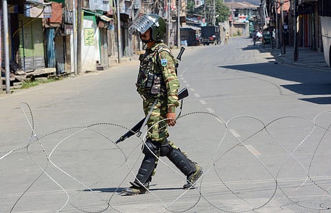 An Indian soldier patrols a curfewed street in Kashmir. (Photo| PTI)