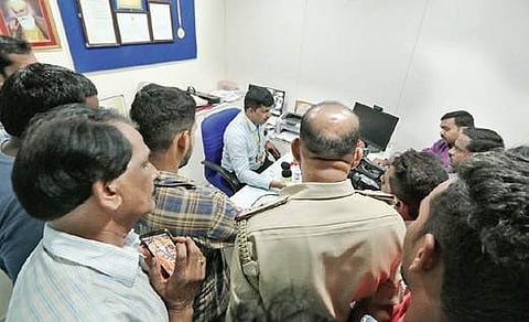 Irate bank customers confront the PMC Bank manager in Shivamogga on 24 September 2019. (Photo | Shimoga Nandan, EPS)